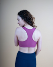 back view of a mom wearing a pink nursing sports bra with racerback & fig tank
