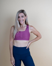 Mom wearing pink breastfeeding sports bra with dropdown cup unclipped
