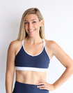 mother wearing nursing sports bra in navy and white 