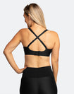 Back view of active mom wearing black nursing sports bra with crossover straps