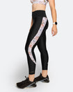 Side view of active mom wearing black postpartum compression tights