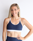 mother wearing nursing sports bra in navy and white 