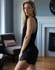 side view of mum wearing mid-waisted maternity and postpartum shorts in black 