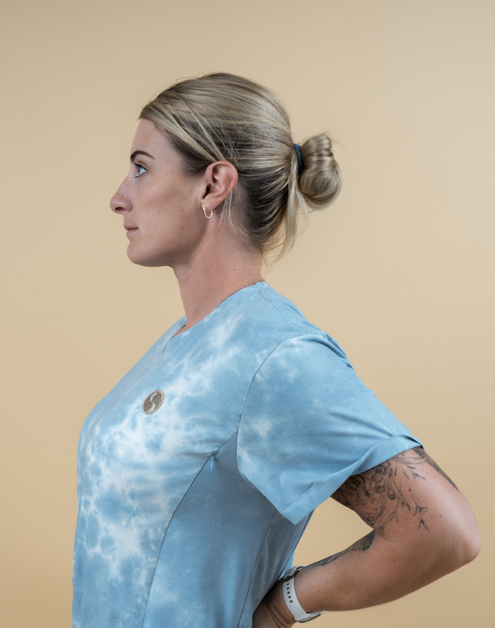 Active mother wearing comfortable and flattering tie-dye, showcasing easy nursing functionality 