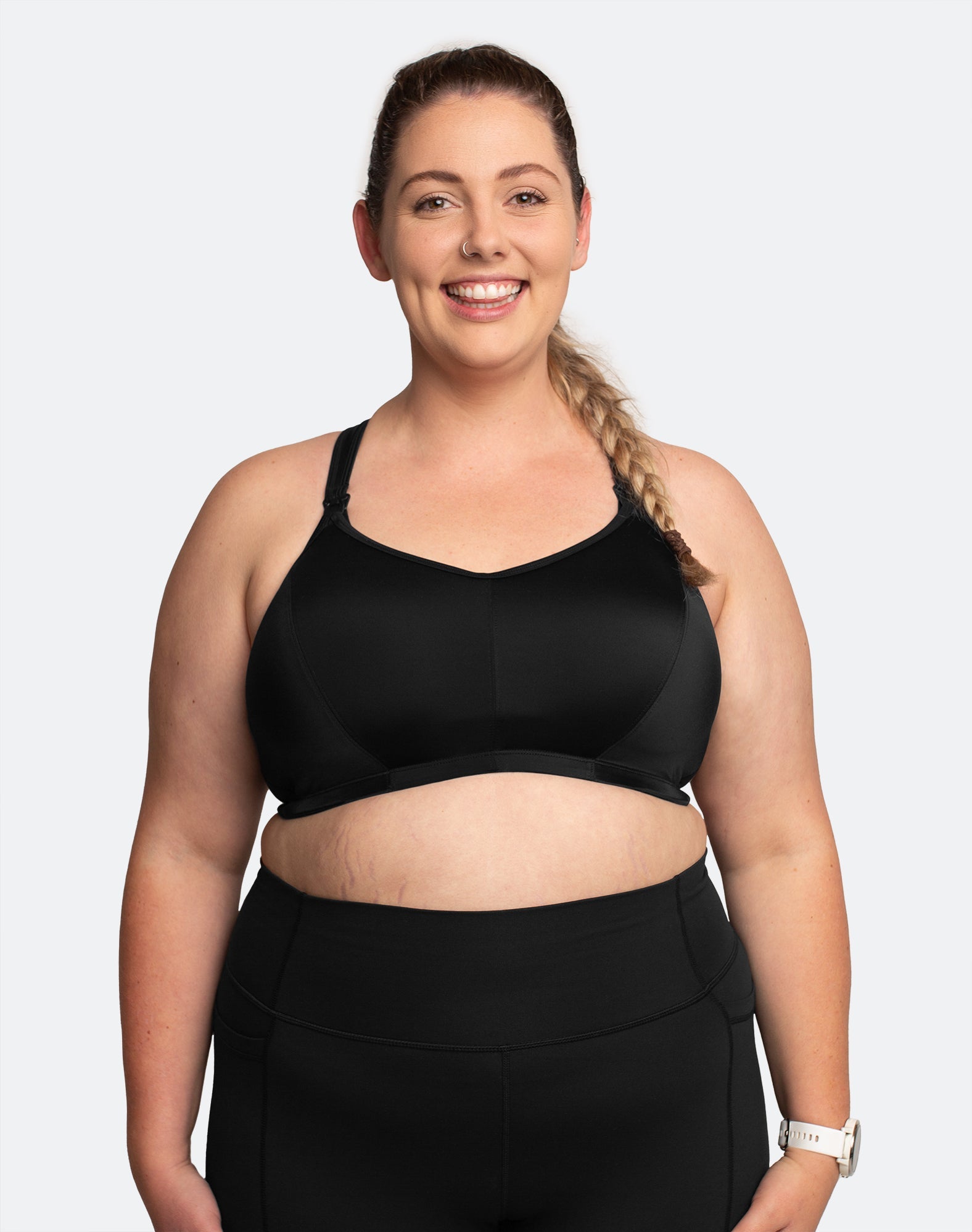 Front view of breastfeeding mum wearing black nursing sports bra