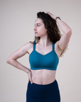 Front view of mother wearing supportive breastfeeding bra in the colour teal