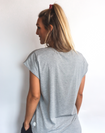 back view of active mom wearing a relaxed fit grey t-shirt with wide armholes for breastfeeding
