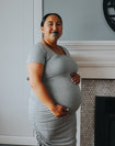 Happy pregnant woman wearing grey marle bamboo maternity dress 