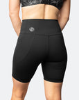 Back view of active mother wearing high waisted postpartum bike shorts