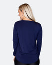 back view of a mum wearing a blue top with a scooped hem