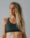 woman wearing dark green wire free exercise crop bra for moderate intensity exercise